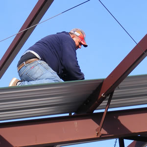 construction worker performing re-roofing preparation